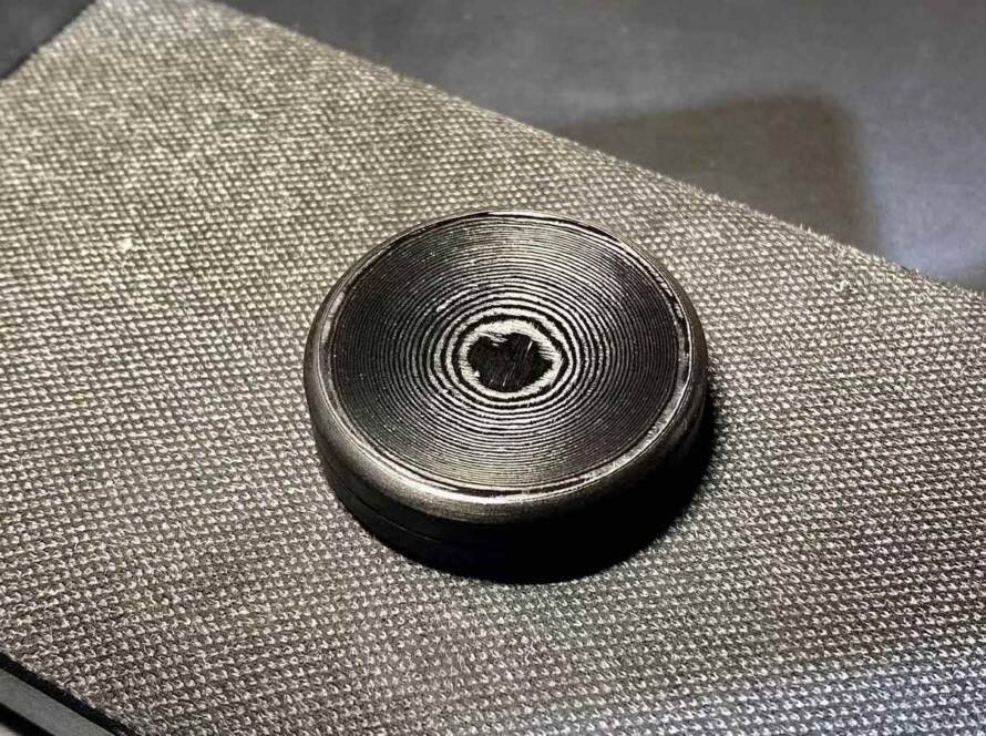 Machined forged carbon disc resting on woven cloth